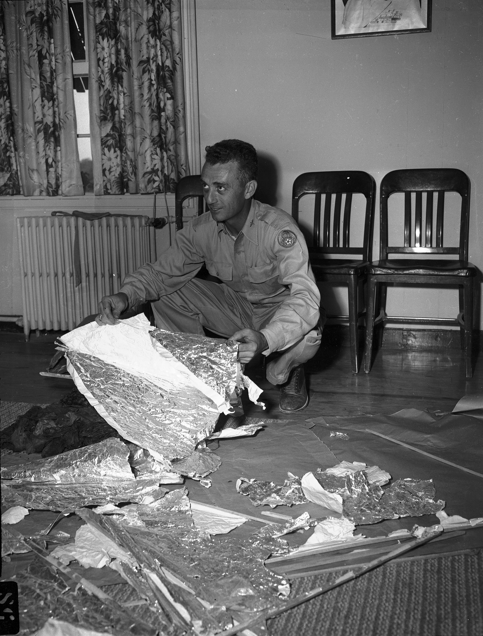 Maj. Jesse Marcel of the 509th Bomb Group poses with recovered debris in Ramey's office, July 8, 1947.