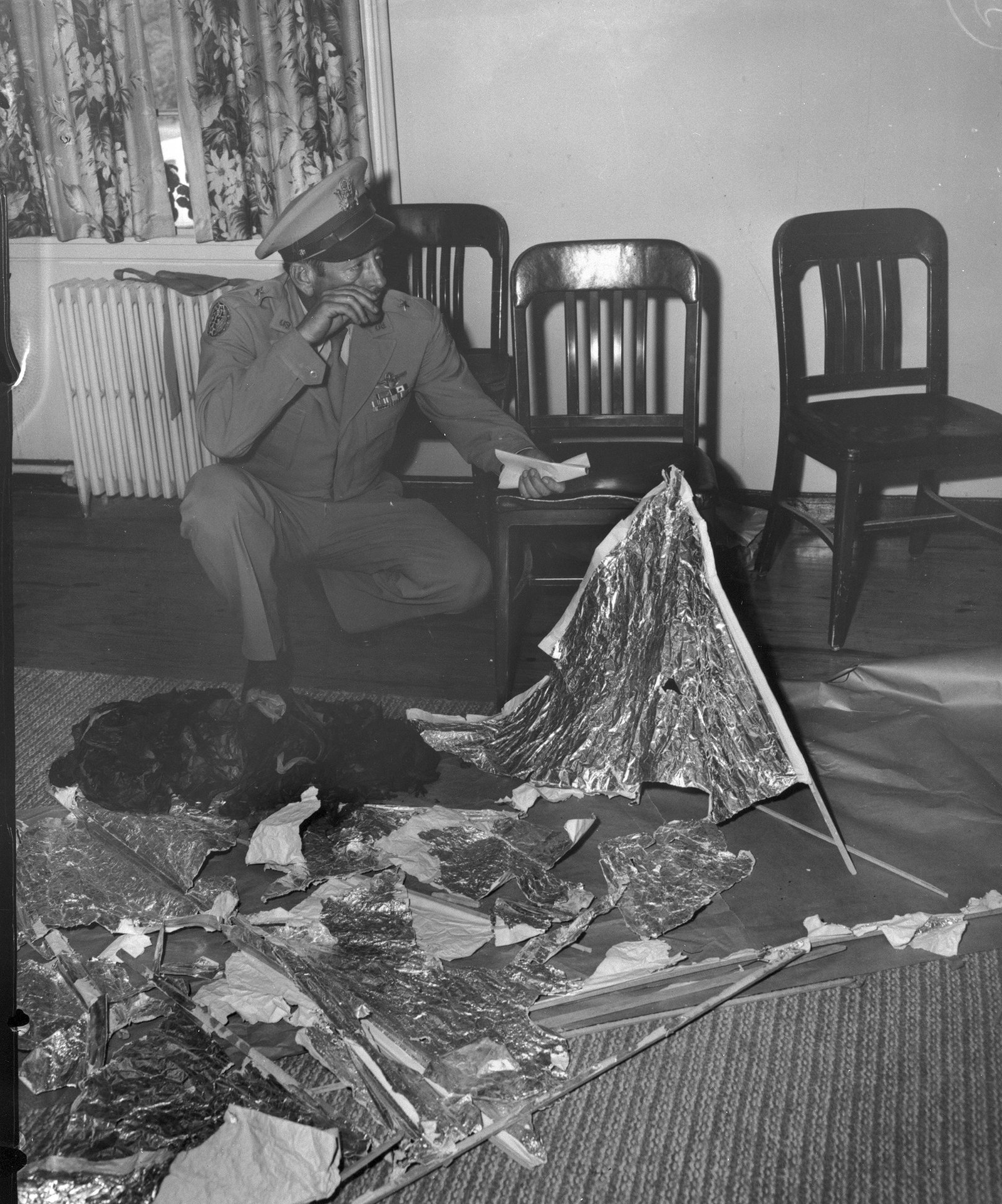 Brig. Gen. Roger Ramey (right) and Col. Thomas DuBose examine debris in Ramey's Fort Worth office, July 8, 1947 — the press event at which the Army walked back its 'flying disc' announcement.